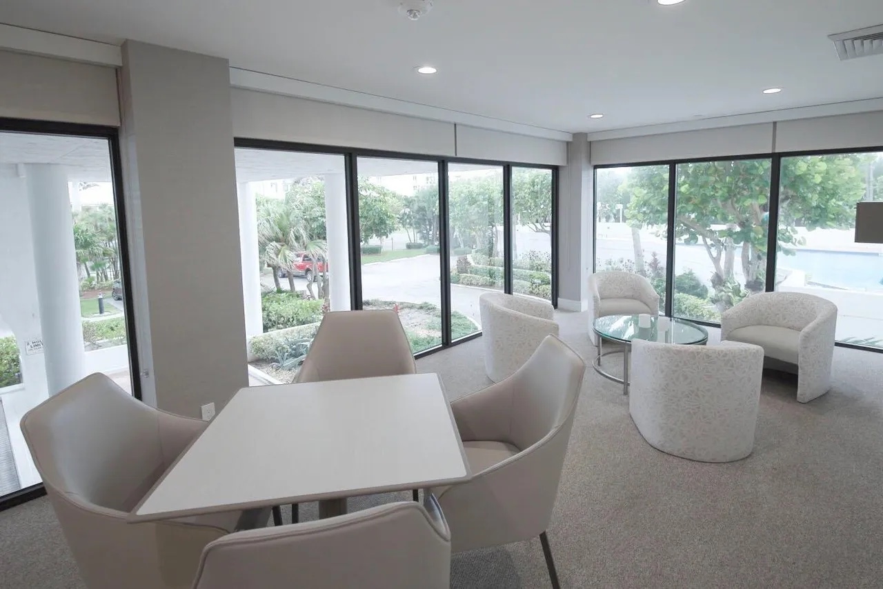 Renovated Casuarina amenity room with flexible seating, contemporary lighting and views toward the landscape