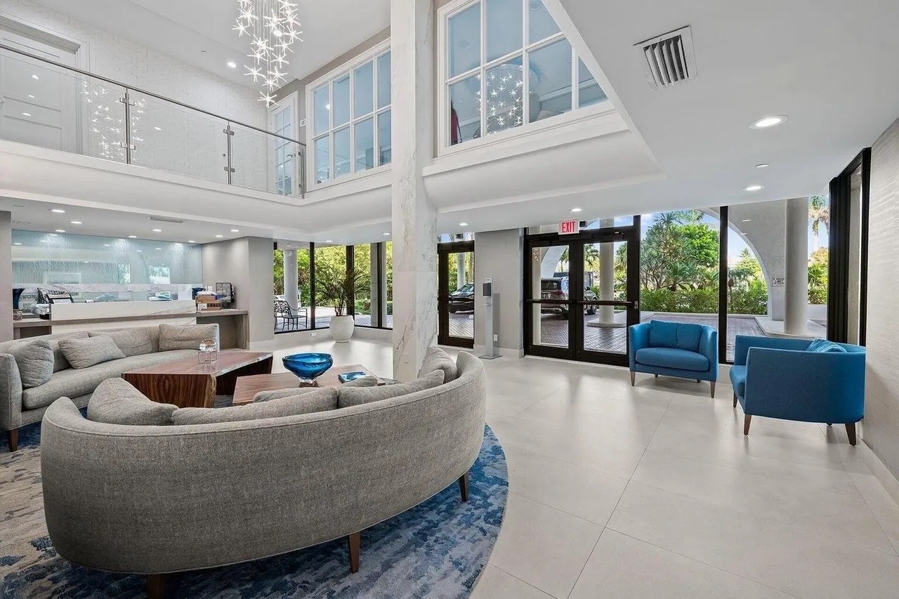 Casuarina lobby renovation with textured wall, sculptural wood tables and contemporary seating