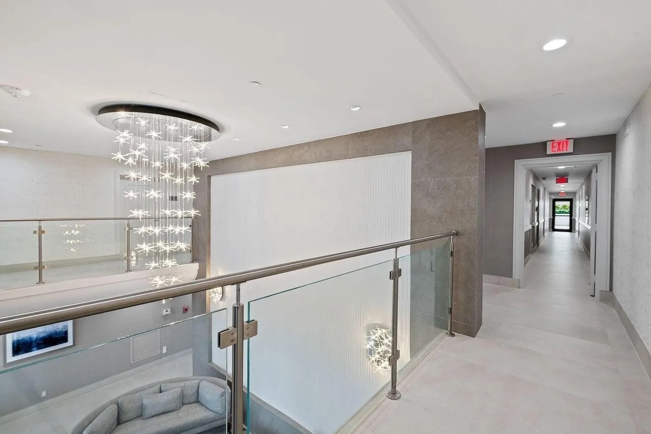 Upper-level glass balustrade and corridor overlooking the renovated Casuarina lobby