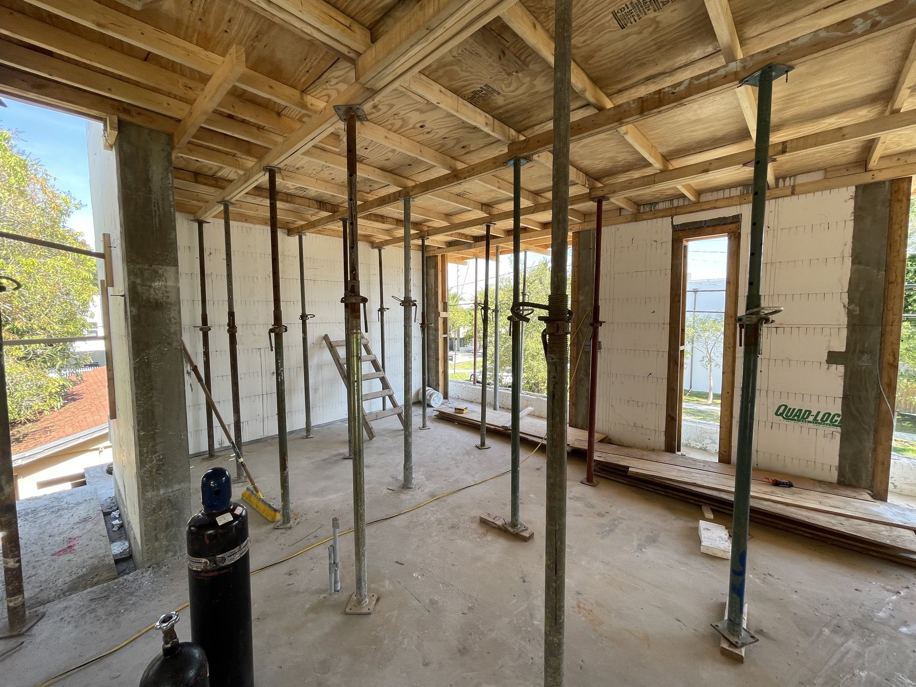 Upper-floor formwork and temporary shoring during construction of a Miami residence