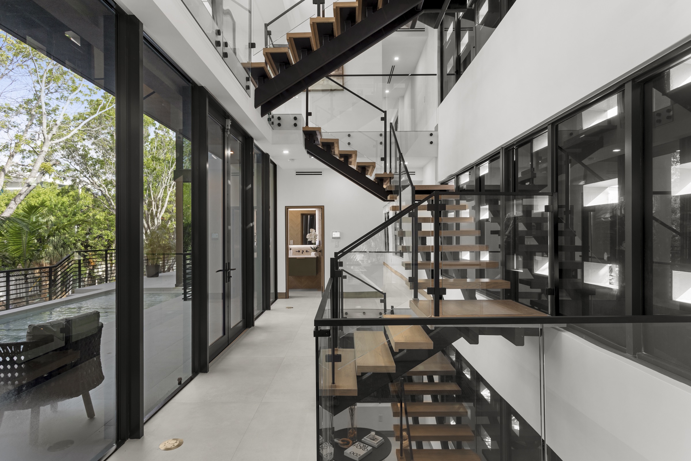 Central open-riser staircase connecting the levels of Fair Isle Residence