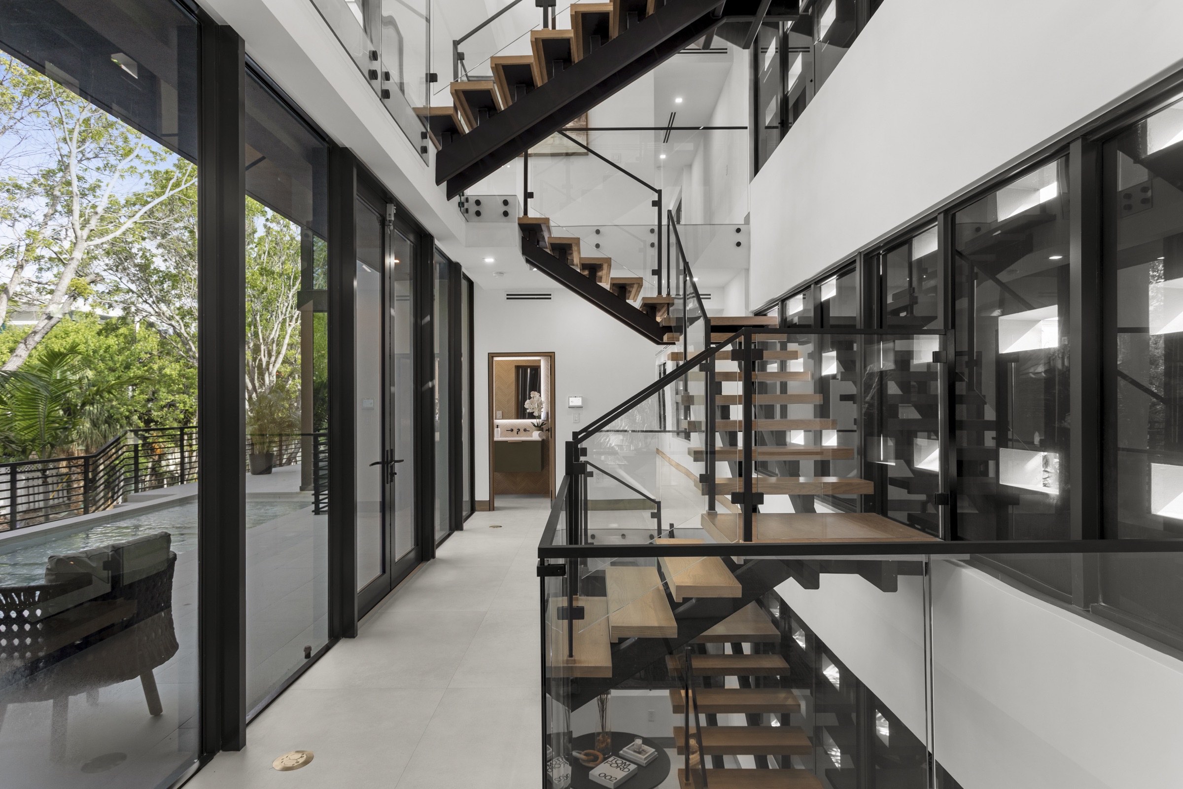 Central Fair Isle Residence stair conceived as an ascent among aerial roots and vertical light.