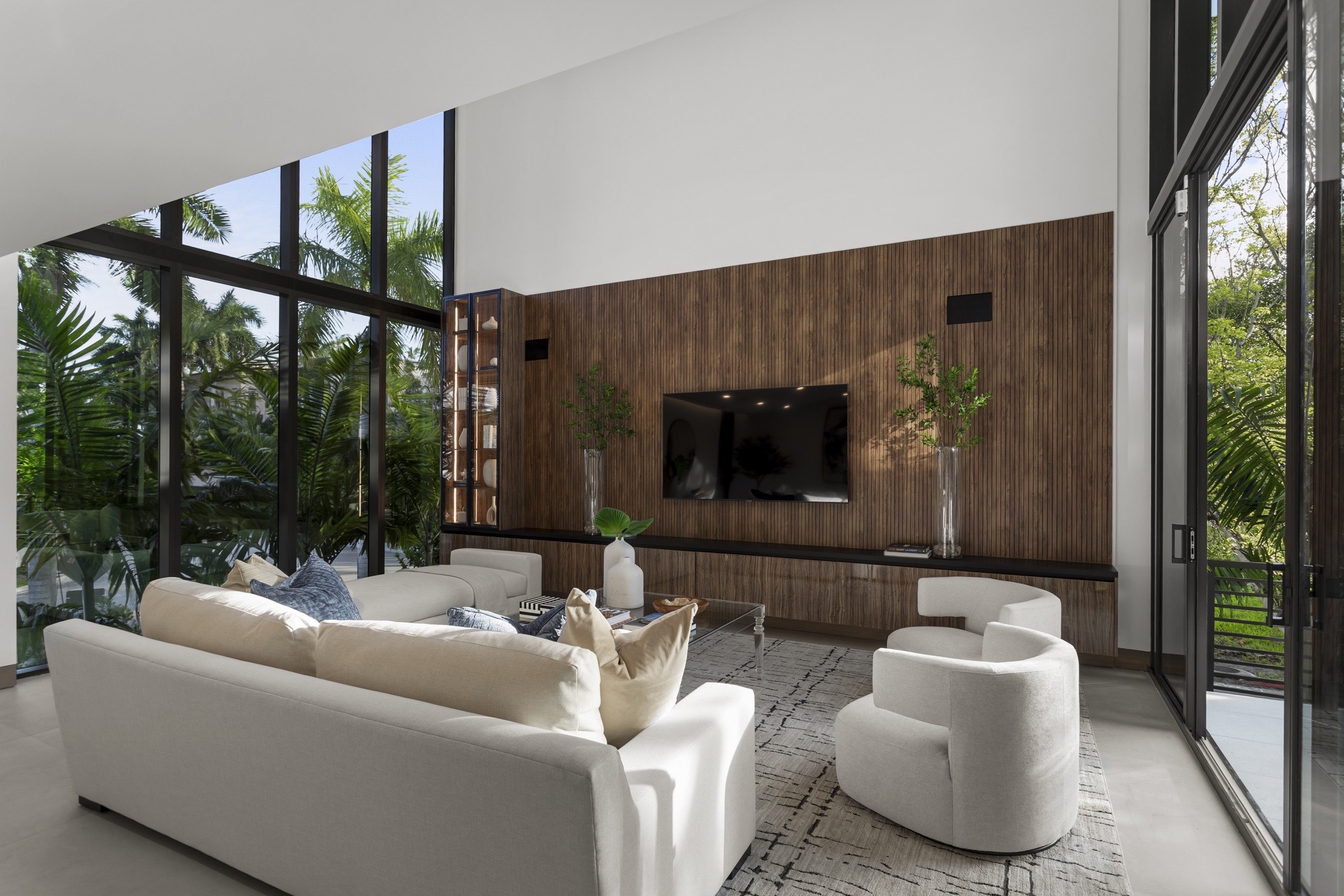 Fair Isle Residence living space opening toward water and tropical landscape in Coconut Grove, Miami.