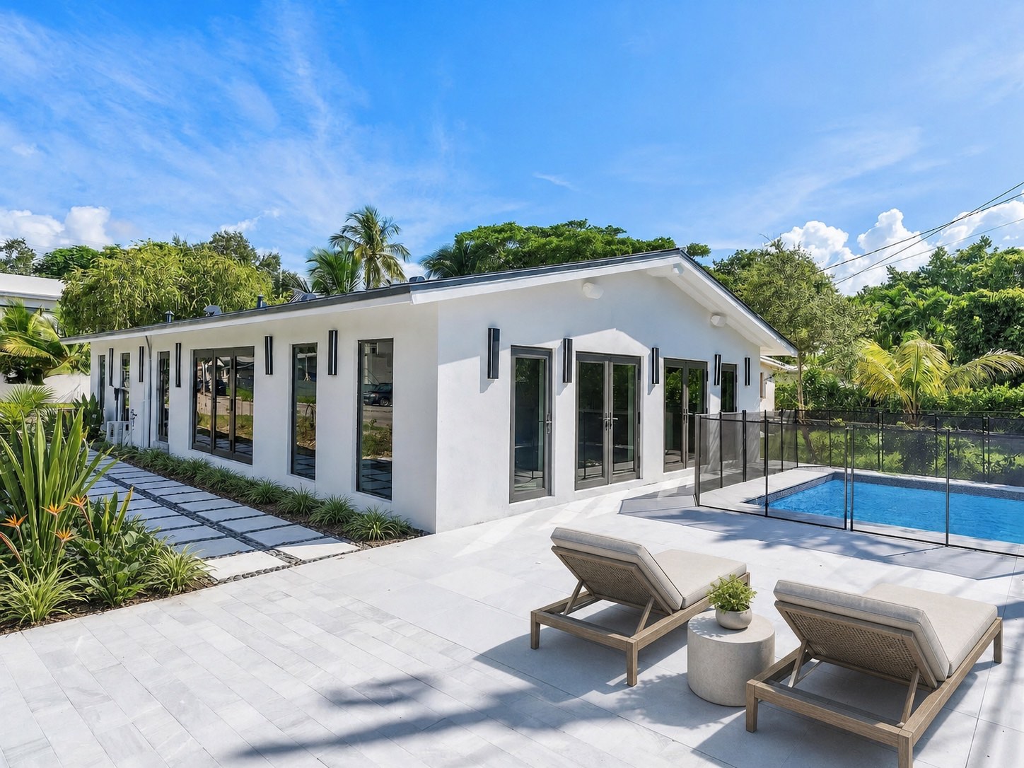 Frow Avenue Residence after a complete Coconut Grove renovation, with the house and pool courtyard composed as one environment.