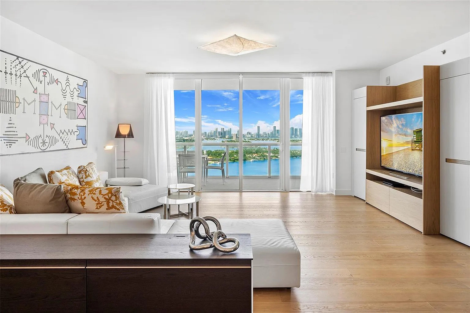 Bright living room at Icon South Beach Apartment opening toward the bay and Miami skyline