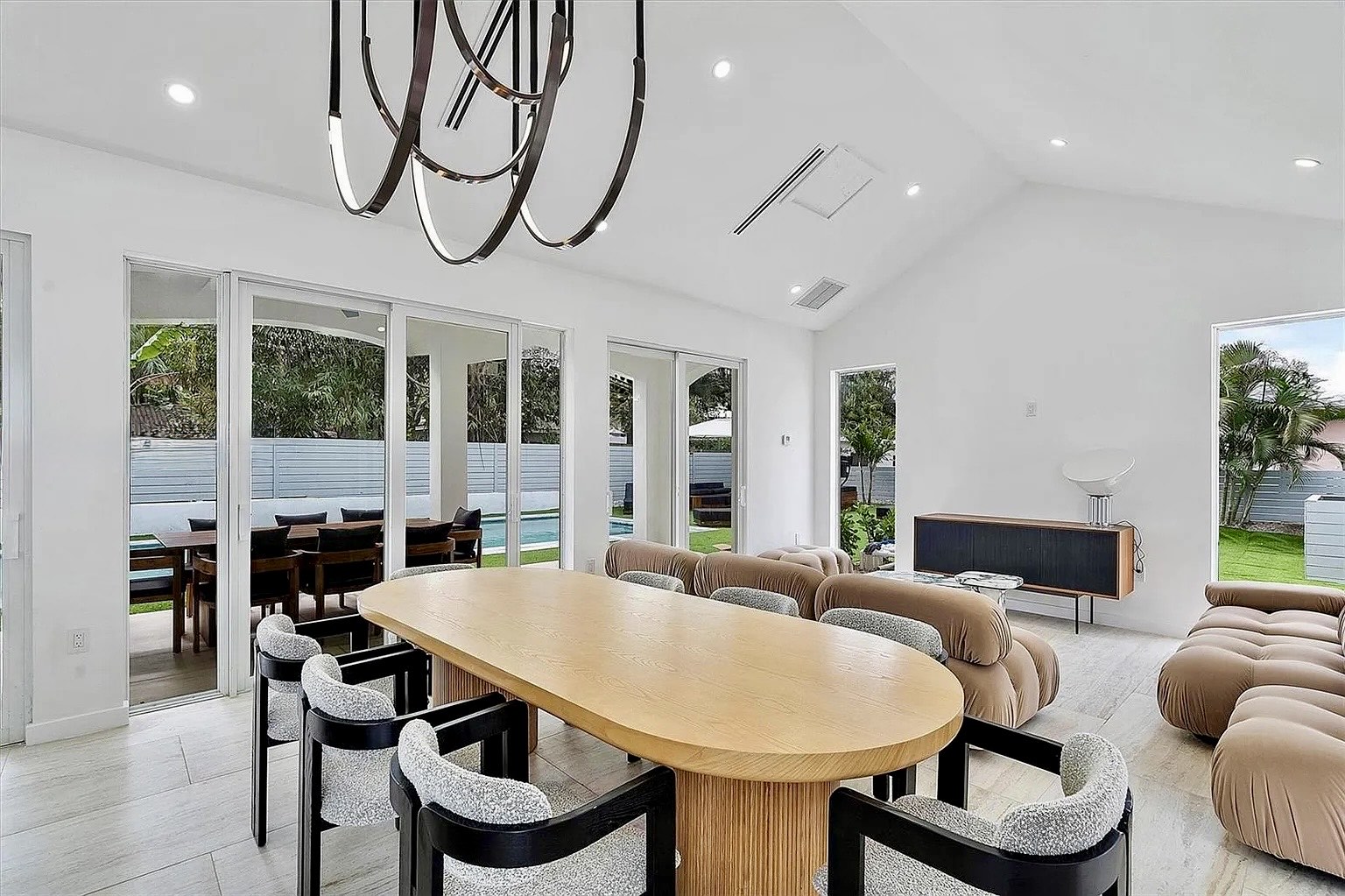 Dining area at NE 45th Street Residence with direct views to the pool and covered terrace