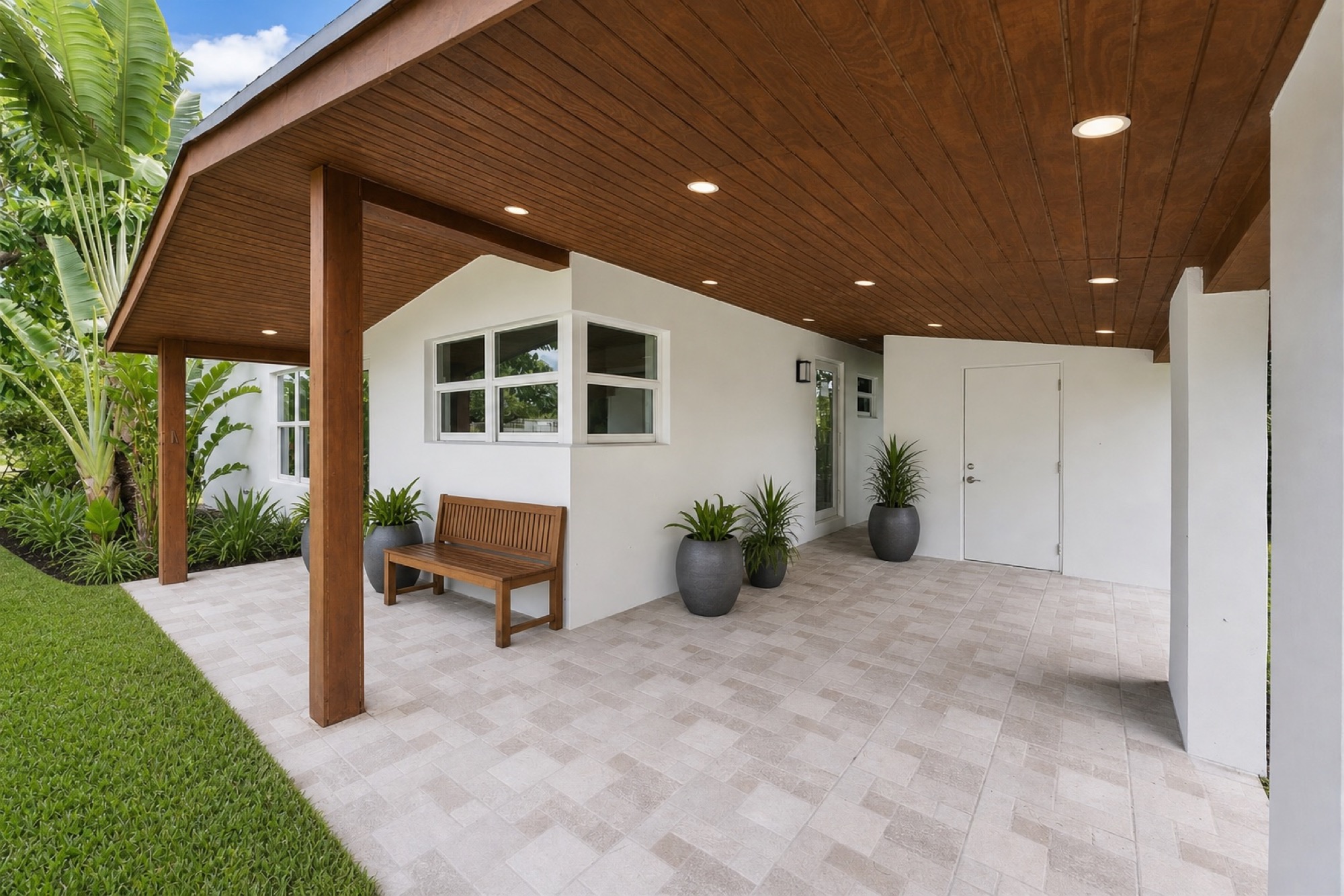Timber-covered patio threshold between interior and garden